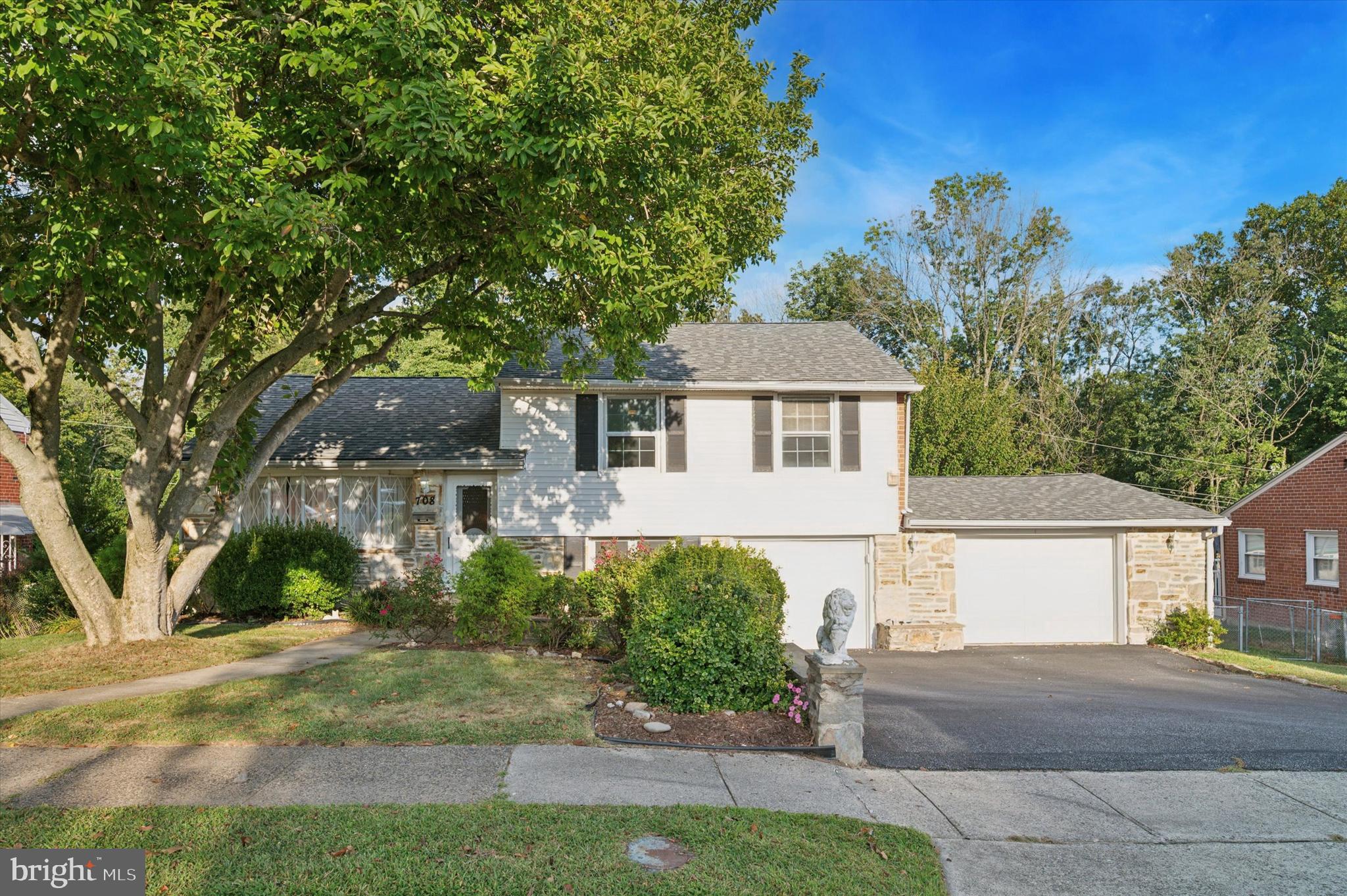 708 Cambridge Road Brookhaven, PA 19015 - Photo 20 of 20 a front view of a house with a garden