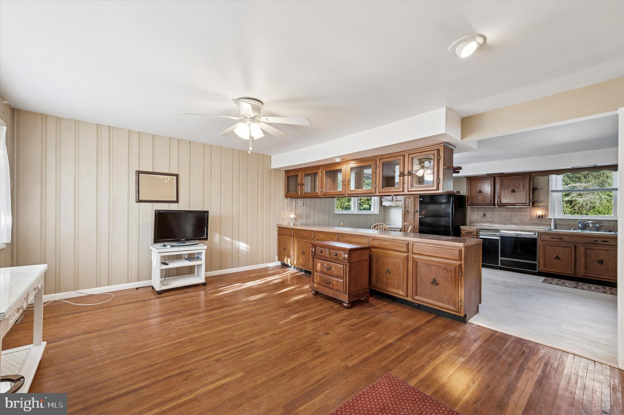 708 Cambridge Road Brookhaven, PA 19015 - Photo 2 of 20 a kitchen with stainless steel appliances kitchen island granite countertop a stove a sink and a wooden floors