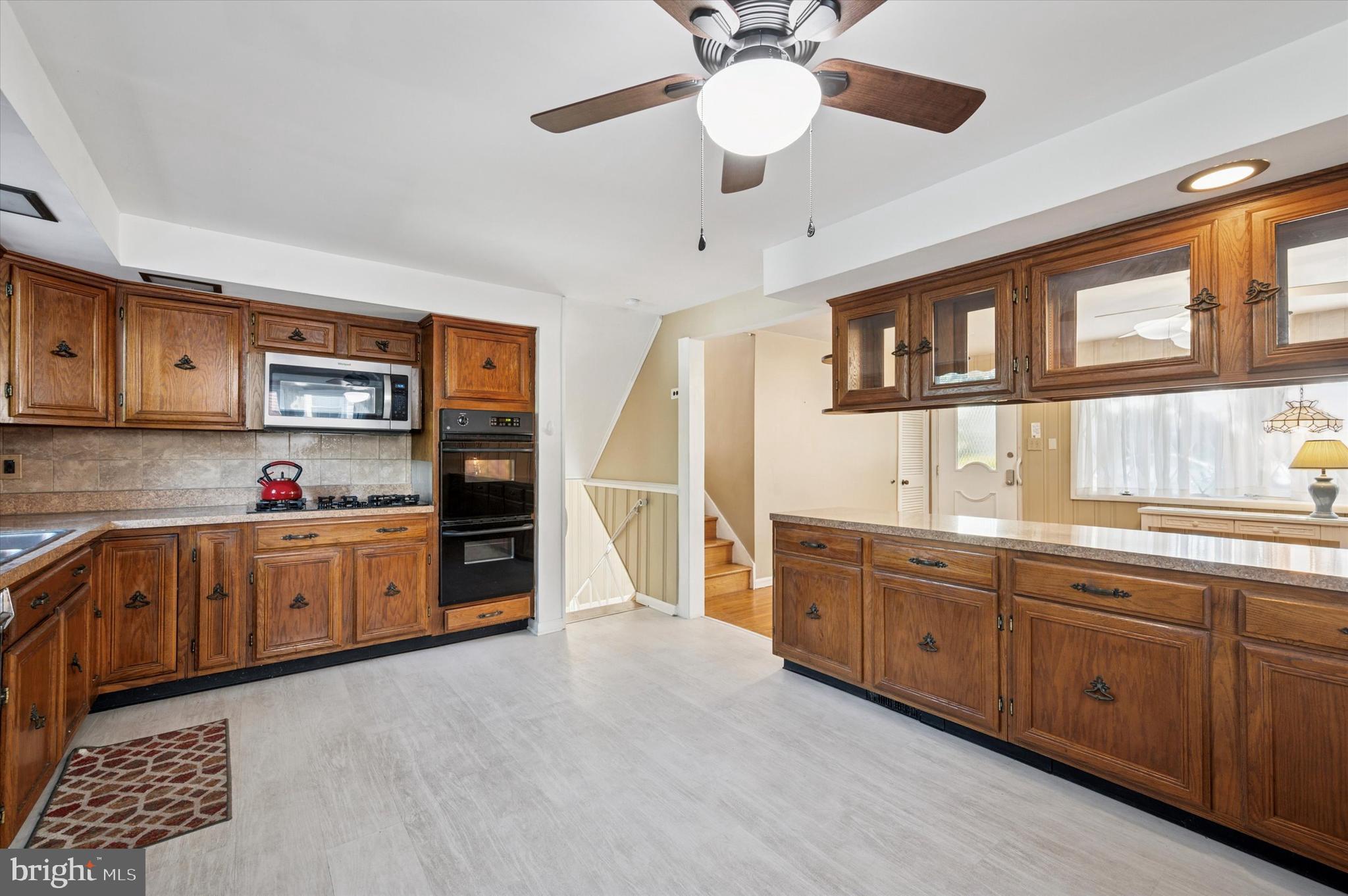 708 Cambridge Road Brookhaven, PA 19015 - Photo 7 of 20 a large kitchen with stainless steel appliances granite countertop a lot of counter space and wooden floors