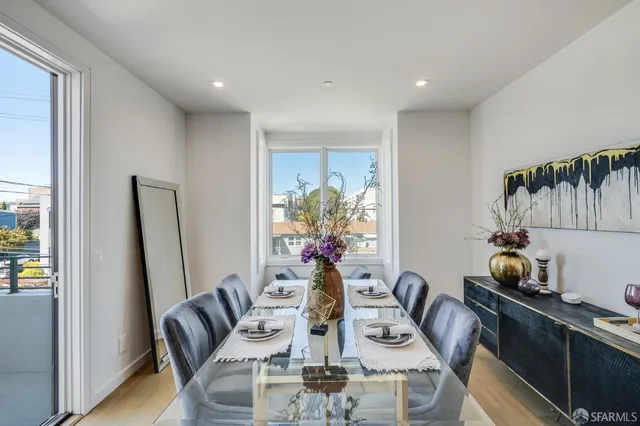 a view of kitchen with refrigerator and dining table