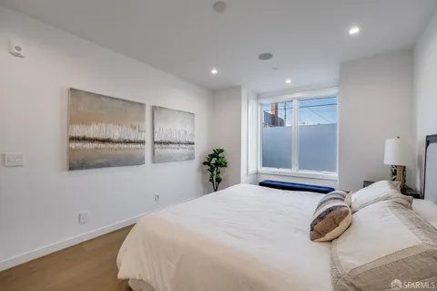 a bedroom with a bed and a painting