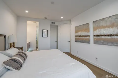 a bedroom with a bed and night stand