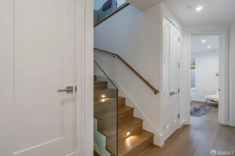 a view of a hallway with wooden floor and entryway