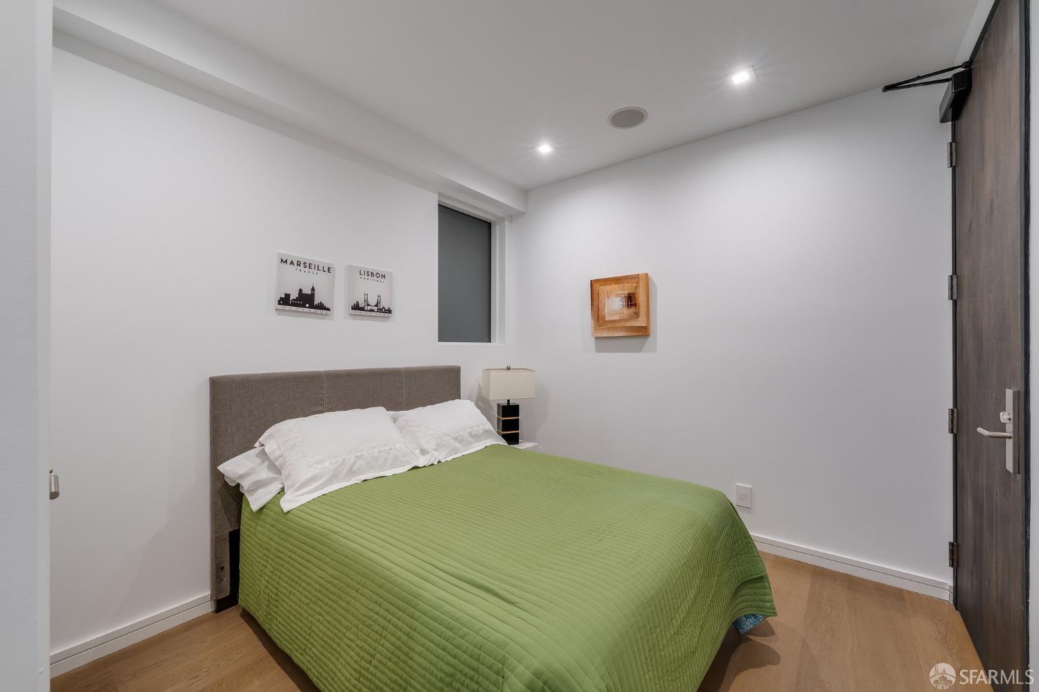 2829 25th Street, Unit 3 San Francisco, CA 94110 - Photo 25 of 36 a bedroom with a bed and wall painting