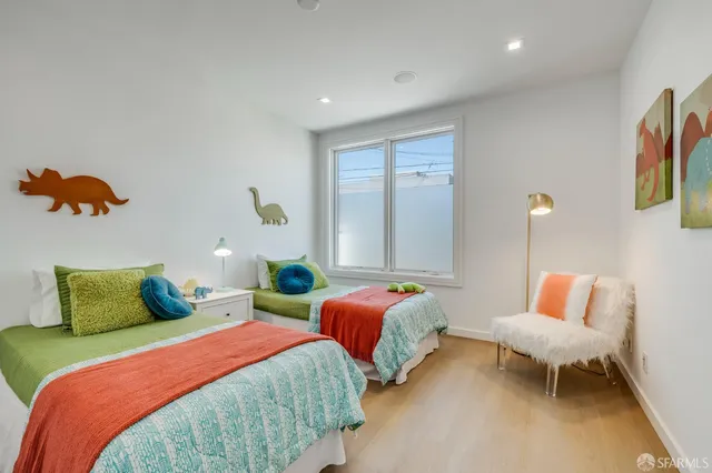 a bedroom with two beds and a lamp