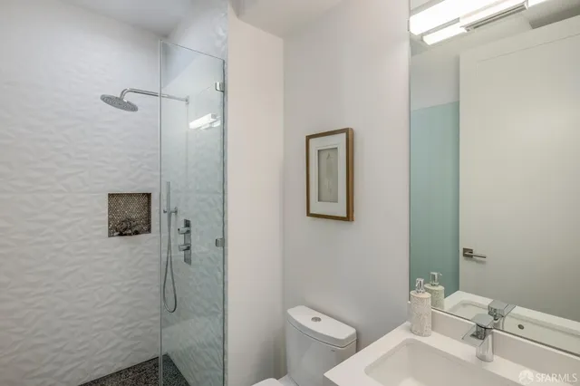 a bathroom with a toilet and a shower