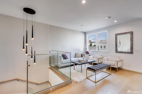 a living room with furniture and a ceiling fan