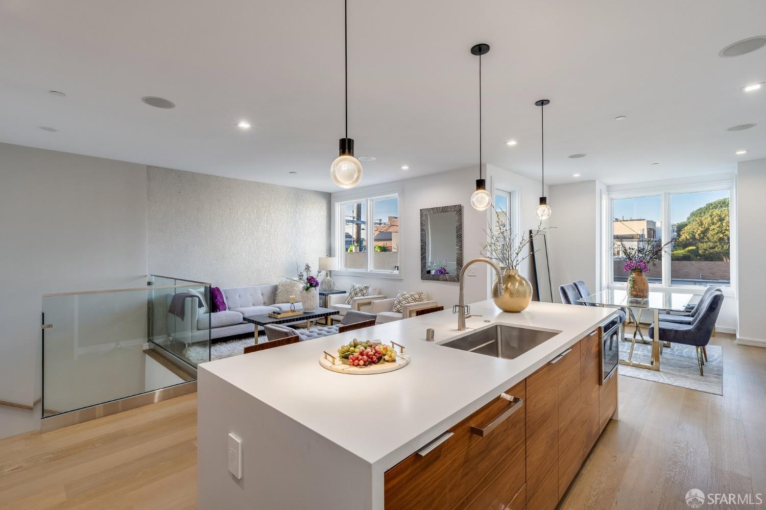 2829 25th Street, Unit 3 San Francisco, CA 94110 - Photo 5 of 36 a kitchen with a stove a counter space a sink and living room view