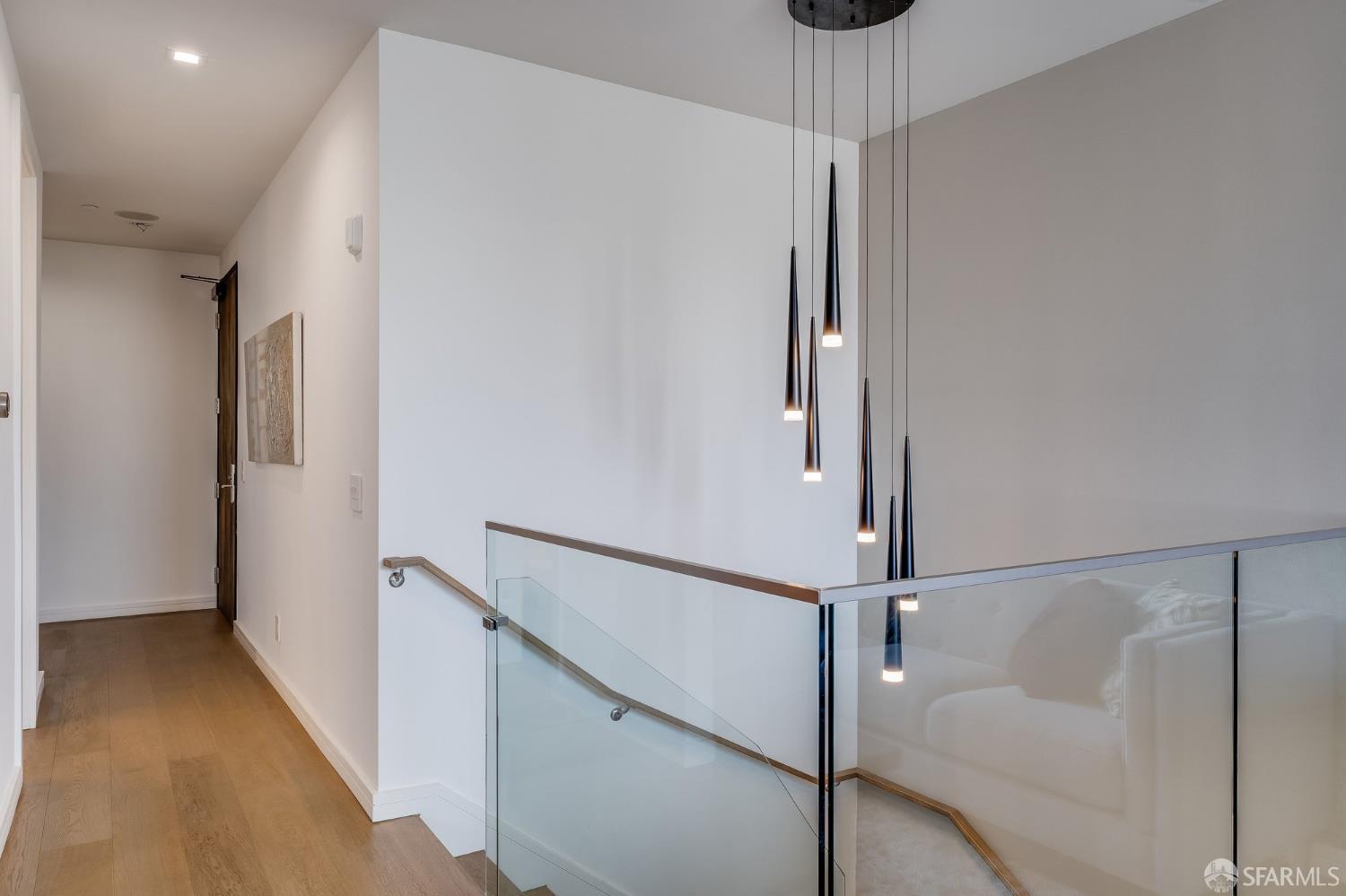 2829 25th Street, Unit 3 San Francisco, CA 94110 - Photo 6 of 39 a view of a hallway with a chandelier