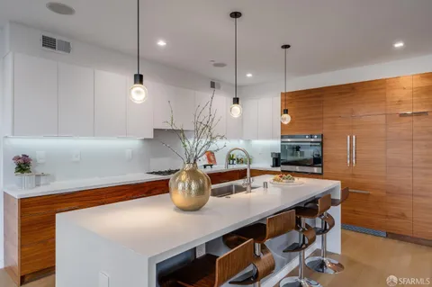 a kitchen with a table a stove and cabinets