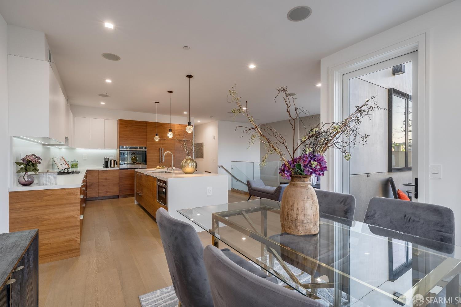 2829 25th Street, Unit 3 San Francisco, CA 94110 - Photo 8 of 36 a living room with furniture kitchen view and a chandelier