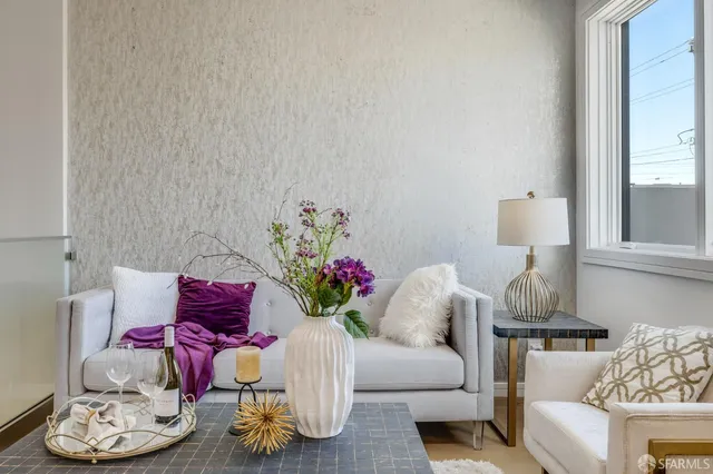 a living room with furniture and a lamp