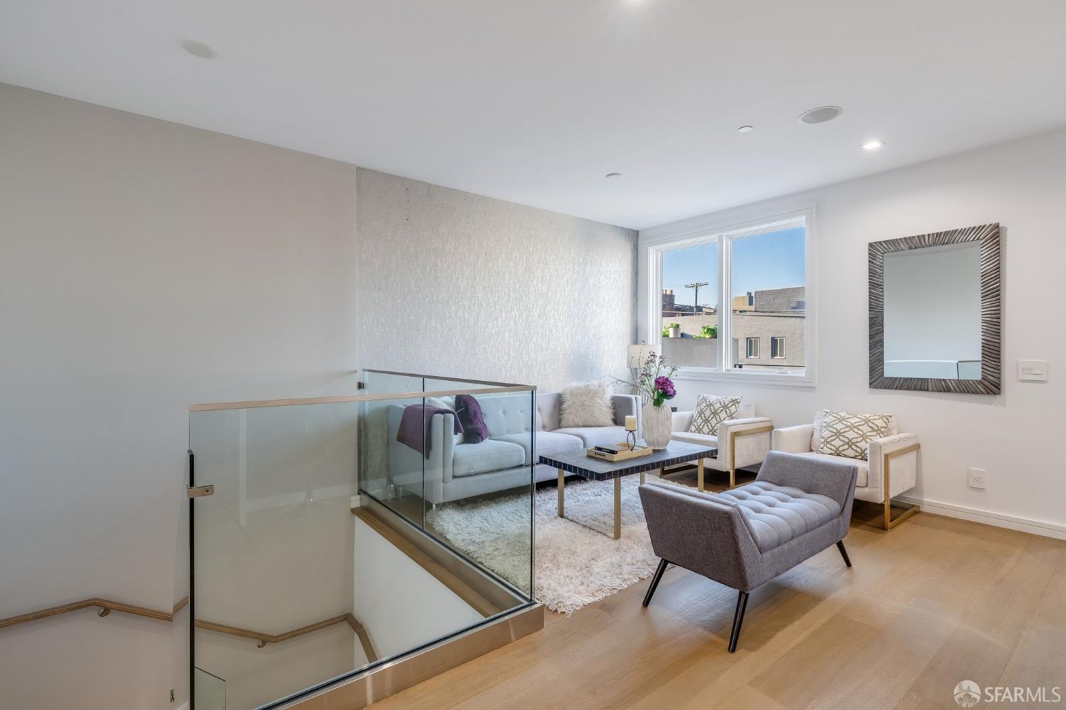 2829 25th Street, Unit 3 San Francisco, CA 94110 - Photo 10 of 36 a living room with furniture and a wooden floor
