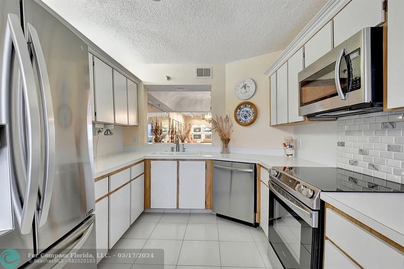 Kitchen , Bright , Open & Spacious with all New Stainless Steel Appliances, Refaced Cabinetry & Additional Pantry and Shelving! Most Cabinets Have Pull Out Drawers!