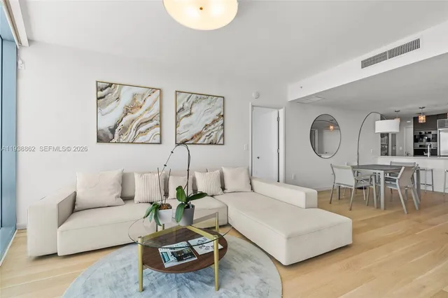 a living room with furniture a rug and a wall painting