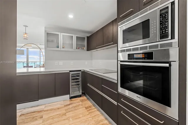 a kitchen with stainless steel appliances and cabinets