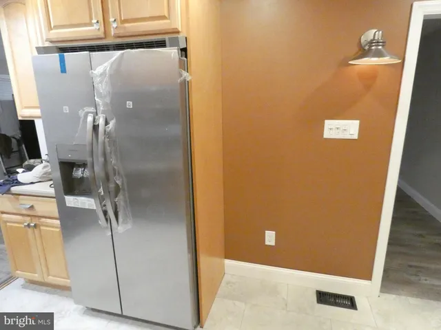 a kitchen with stainless steel appliances granite countertop a sink a stove and a refrigerator