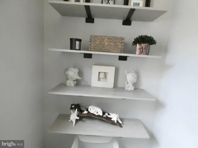 a shelf with books and knick knacks on it
