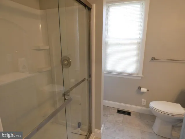 a bathroom with a tub sink and a large mirror