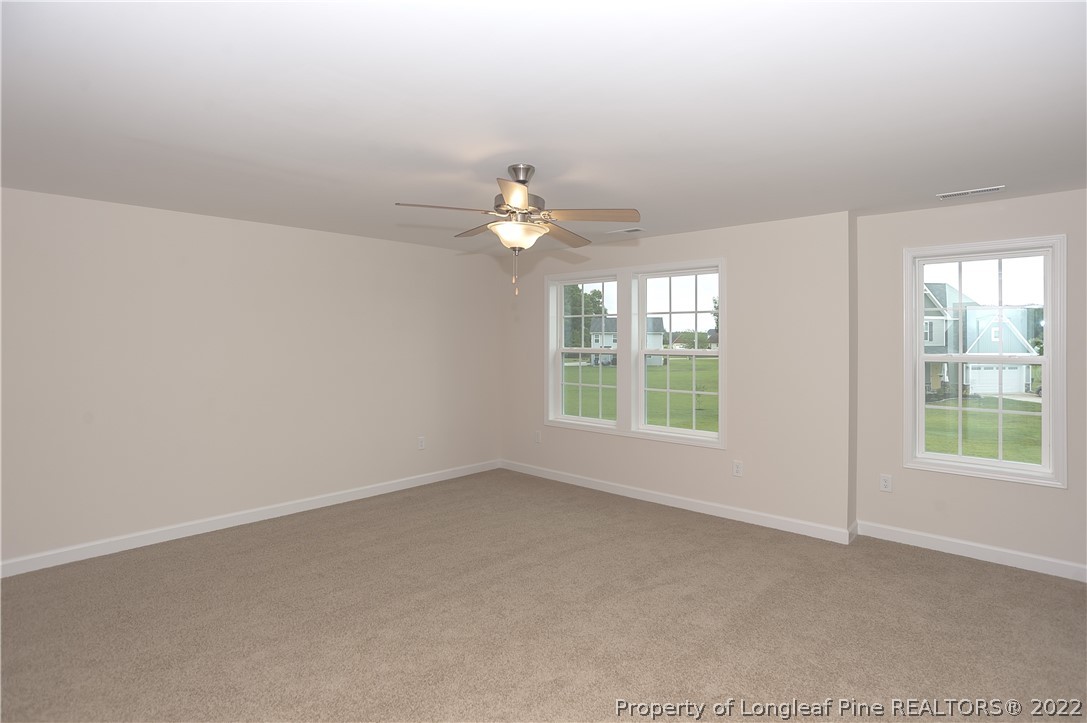 312 Mill Ridge Court Godwin, NC 28344 - Photo 16 of 32 an empty room with windows and chandelier fan