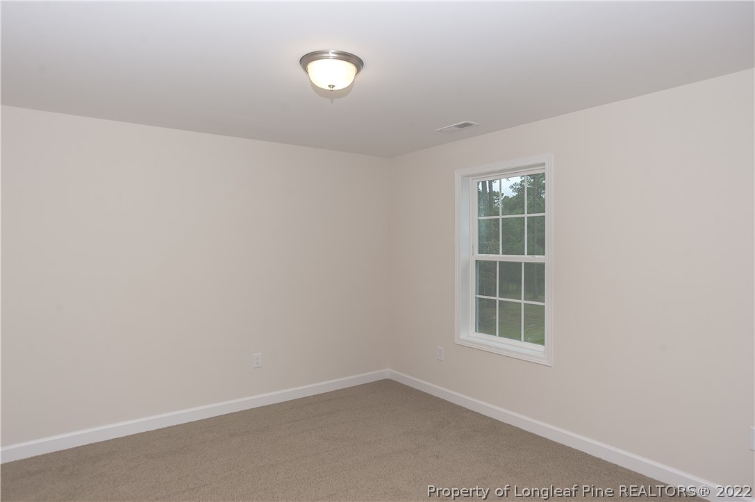 312 Mill Ridge Court Godwin, NC 28344 - Photo 21 of 32 an empty room with windows