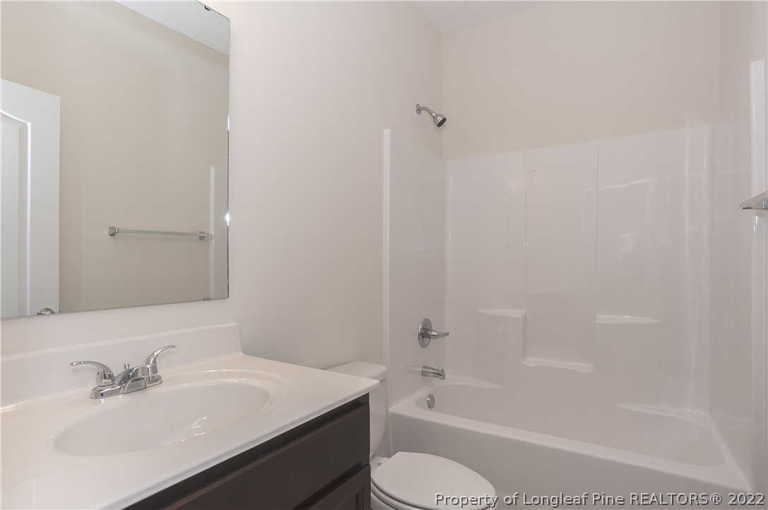 312 Mill Ridge Court Godwin, NC 28344 - Photo 26 of 32 a bathroom with a sink toilet and bathtub