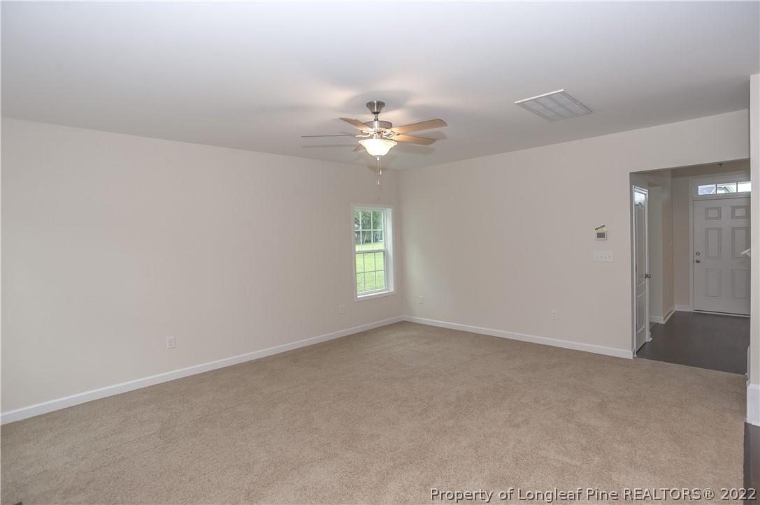 312 Mill Ridge Court Godwin, NC 28344 - Photo 29 of 32 an empty room with a window and a ceiling fan