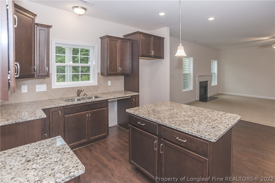 312 Mill Ridge Court Godwin, NC 28344 - Photo 8 of 32 a kitchen with a sink stove and refrigerator