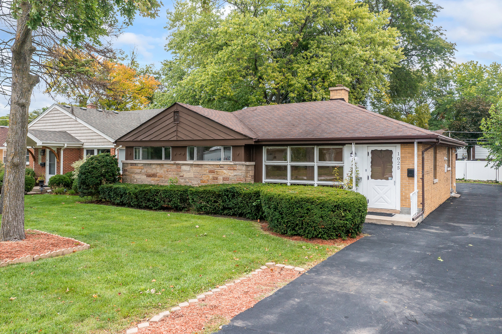 a front view of a house with a garden