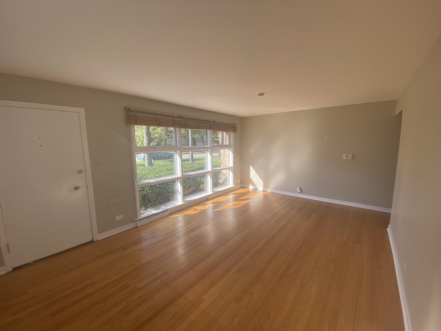 1025 South Dee Road Park Ridge, IL 60068 - Photo 13 of 13 wooden floor in an empty room with a window