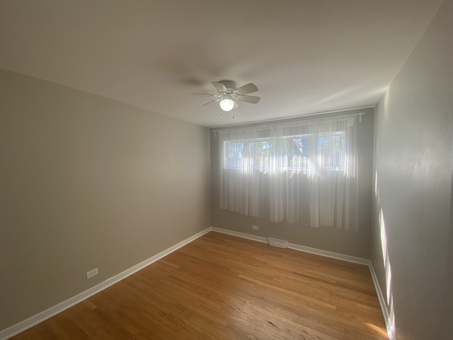 1025 South Dee Road Park Ridge, IL 60068 - Photo 5 of 13 an empty room with wooden floor and windows