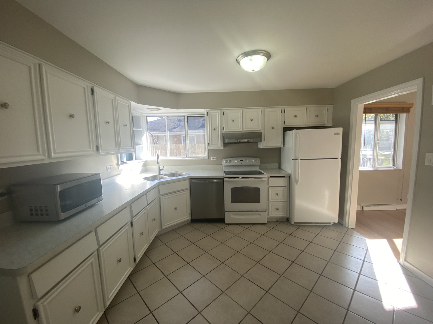 1025 South Dee Road Park Ridge, IL 60068 - Photo 10 of 13 a kitchen with a sink a refrigerator and cabinets