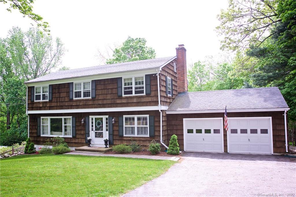 a view of a house with a yard and sitting area