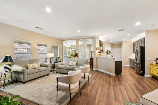 a living room with furniture and kitchen view