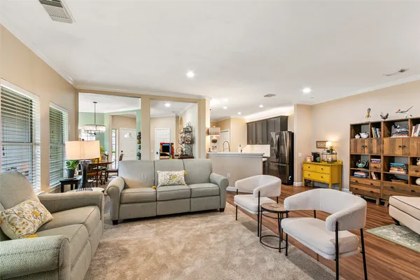 a living room with furniture kitchen view and a fireplace