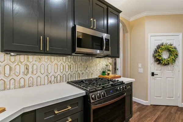 a stove top oven sitting inside of a kitchen