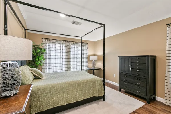 a bedroom with a bed and a dresser