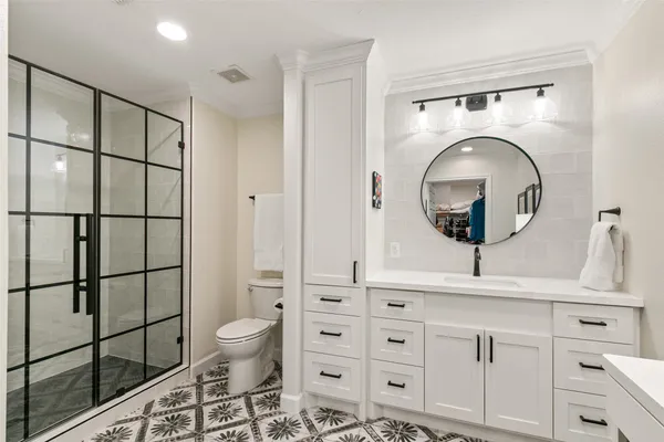 a bathroom with a toilet a sink and mirror