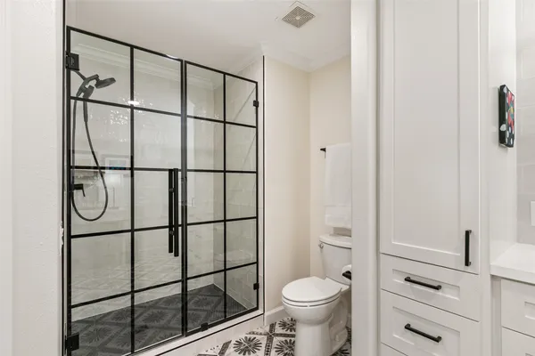 a bathroom with a shower toilet and sink