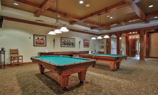 a room with pool table and windows
