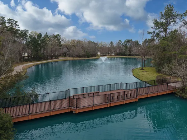 a view of a lake with a bench in the background