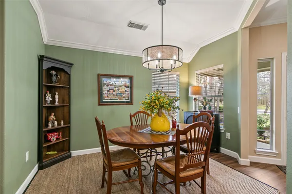 a view of a dining room with furniture window and wooden floor