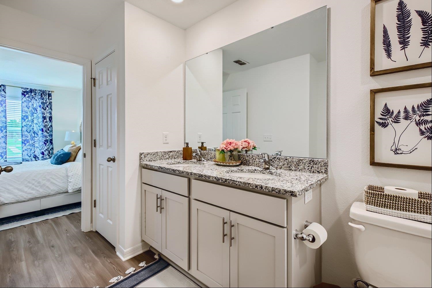 67 Pamplona Drive St. Augustine, FL 32086 - Photo 24 of 66 a bathroom with a granite countertop sink a toilet and a mirror