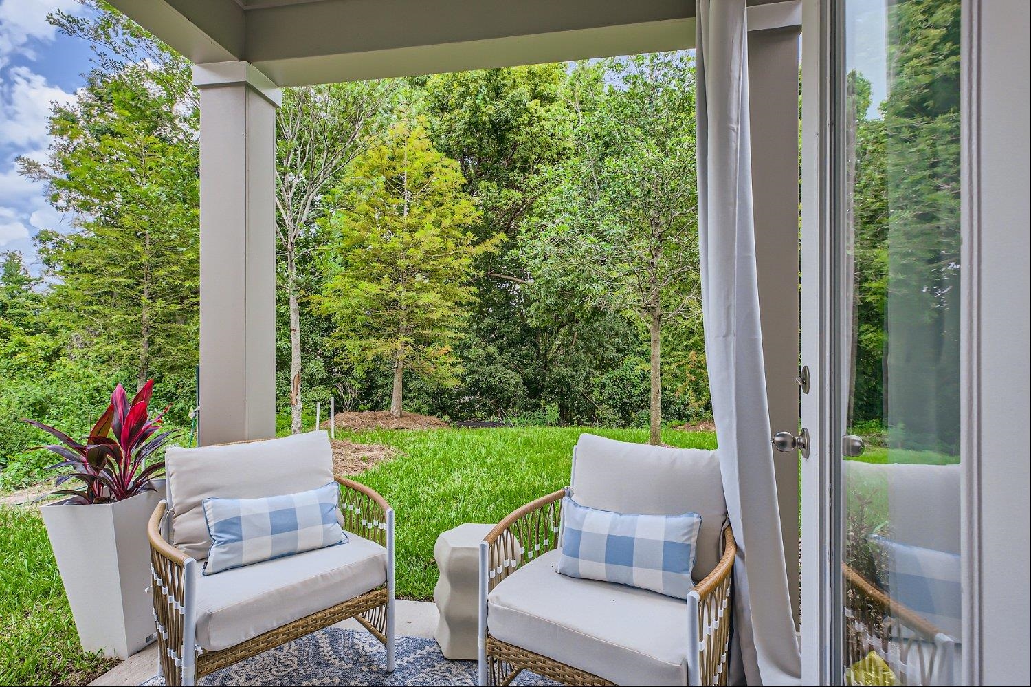 67 Pamplona Drive St. Augustine, FL 32086 - Photo 61 of 66 a view of a patio with table and chairs and potted plants