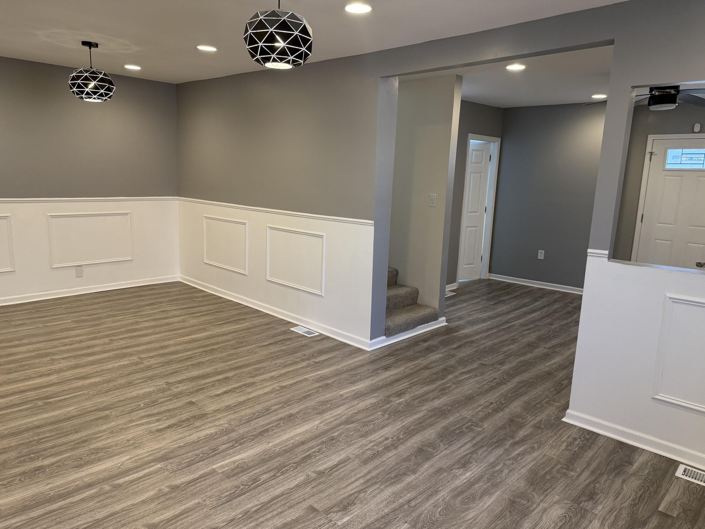 634 Kentucky Street Gary, IN 46402 - Photo 4 of 18 an empty room with wooden floor and windows