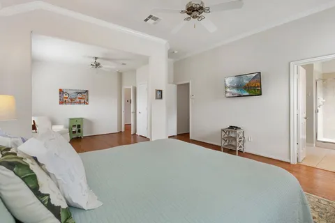 a bedroom with a bed and a chandelier