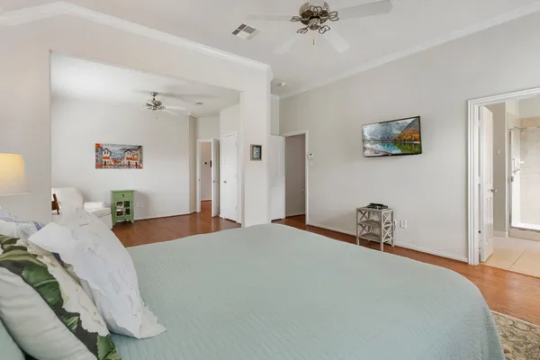 a bedroom with a bed and a chandelier