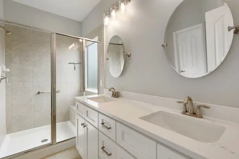 a bathroom with a double vanity sink mirror and double