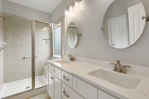 a bathroom with a double vanity sink mirror and double
