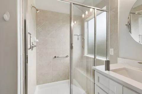 a bathroom with a shower and a sink
